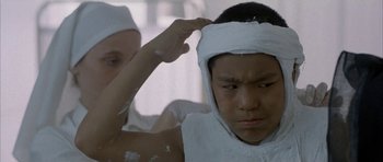 Movie still from “Map of the Human Heart” (1992), directed by Vincent Ward – A man with bandages on his head and another man with bandage on his head; Close Up shot, Low angle