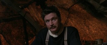 Movie still from “Map of the Human Heart” (1992), directed by Vincent Ward – A man with a mustache wearing an apron; Close Up shot, High angle