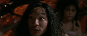 Movie still from “Map of the Human Heart” (1992), directed by Vincent Ward – A person with long black hair; Close Up shot, Low angle