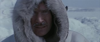Movie still from “Map of the Human Heart” (1992), directed by Vincent Ward – A person wearing a hooded jacket; Close Up shot, Low angle