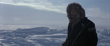Movie still from “Map of the Human Heart” (1992), directed by Vincent Ward – A man standing in the middle of a snow covered field; Medium shot, Over the shoulder angle