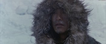 Movie still from “Map of the Human Heart” (1992), directed by Vincent Ward – A man in a fur coat is looking into the camera; Close Up shot, Low angle