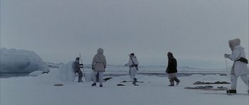 Movie still from “Map of the Human Heart” (1992), directed by Vincent Ward – A group of people standing on top of a snow covered slope; Extreme Wide shot, Low angle