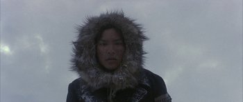 Movie still from “Map of the Human Heart” (1992), directed by Vincent Ward – A man wearing a fur coat and a fur hat; Medium shot, Low angle