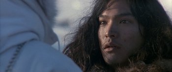Movie still from “Map of the Human Heart” (1992), directed by Vincent Ward – A person with long black hair; Close Up shot, Over the shoulder angle