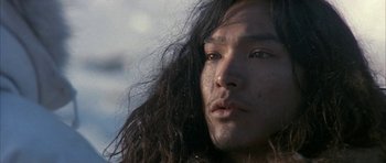 Movie still from “Map of the Human Heart” (1992), directed by Vincent Ward – A person with long black hair; Close Up shot, Low angle