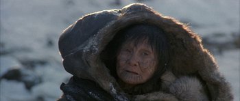Movie still from “Map of the Human Heart” (1992), directed by Vincent Ward – An older woman with a fur coat on her head; Close Up shot, High angle