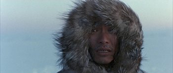 Movie still from “Map of the Human Heart” (1992), directed by Vincent Ward – A man wearing a fur coat and a fur hat; Close Up shot, High angle