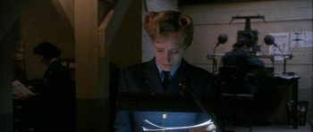 Movie still from “Map of the Human Heart” (1992), directed by Vincent Ward – A woman in uniform looking down at a book; Close Up shot, Low angle