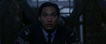 Movie still from “Map of the Human Heart” (1992), directed by Vincent Ward – A man wearing a uniform looking at the camera; Close Up shot, Low angle