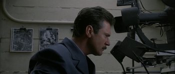 Movie still from “Map of the Human Heart” (1992), directed by Vincent Ward – A person wearing a suit and tie; Close Up shot, Low angle
