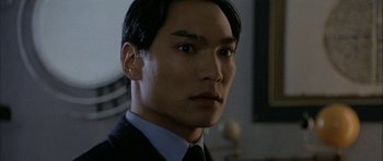 Movie still from “Map of the Human Heart” (1992), directed by Vincent Ward – A person wearing a suit and tie; Close Up shot, Low angle