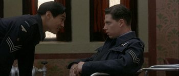 Movie still from “Map of the Human Heart” (1992), directed by Vincent Ward – A man and a woman sitting next to each other on a couch; Close Up shot, Over the shoulder angle