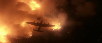 Movie still from “Map of the Human Heart” (1992), directed by Vincent Ward – An airplane is flying through the air on fire; Extreme Wide shot, Low angle