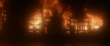 Movie still from “Map of the Human Heart” (1992), directed by Vincent Ward – A large fire is burning in a city; Extreme Wide shot, Low angle