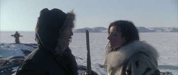 Movie still from “Map of the Human Heart” (1992), directed by Vincent Ward – A man and a woman are standing in the snow; Medium shot, Over the shoulder angle