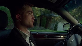 Movie still from “Maps to the Stars” (2014), directed by David Cronenberg – A person sitting in a car looking out the window; Close Up shot, High angle
