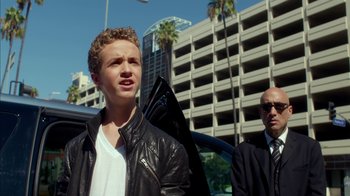 Movie still from “Maps to the Stars” (2014), directed by David Cronenberg – A young man in a black leather jacket and sunglasses; Close Up shot, Low angle
