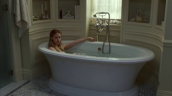 Movie still from “Maps to the Stars” (2014), directed by David Cronenberg – A woman sitting in a bath tub in a bathroom; Wide shot, High angle