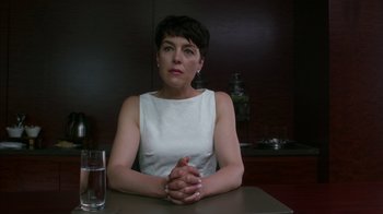 Movie still from “Maps to the Stars” (2014), directed by David Cronenberg – A woman sitting in front of a glass of water; Close Up shot, Low angle