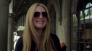 Movie still from “Maps to the Stars” (2014), directed by David Cronenberg – A woman with long blonde hair wearing sunglasses; Close Up shot, Over the shoulder angle