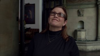 Movie still from “Maps to the Stars” (2014), directed by David Cronenberg – A woman wearing glasses and a black shirt; Close Up shot, Over the shoulder angle