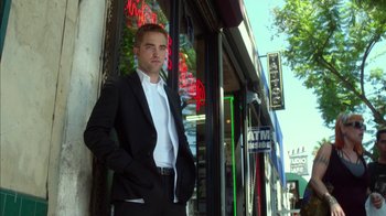 Movie still from “Maps to the Stars” (2014), directed by David Cronenberg – A man standing in front of a store window; Medium shot, Low angle