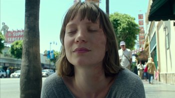Movie still from “Maps to the Stars” (2014), directed by David Cronenberg – A woman with her eyes closed in the middle of the street; Close Up shot, Low angle