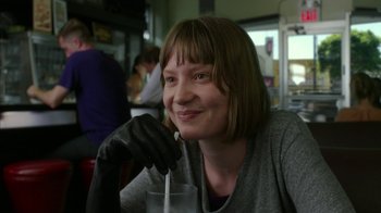 Movie still from “Maps to the Stars” (2014), directed by David Cronenberg – A woman wearing gloves and holding a drink; Close Up shot, Over the shoulder angle