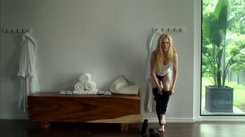 Movie still from “Maps to the Stars” (2014), directed by David Cronenberg – A beautiful woman in a white shirt and black pants; Medium shot, Low angle
