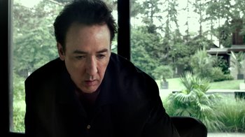 Movie still from “Maps to the Stars” (2014), directed by David Cronenberg – A person sitting in front of a window; Close Up shot, Low angle