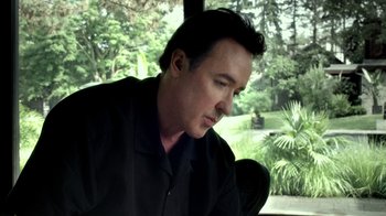 Movie still from “Maps to the Stars” (2014), directed by David Cronenberg – A person looking out a window; Close Up shot, Low angle