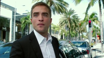 Movie still from “Maps to the Stars” (2014), directed by David Cronenberg – A person wearing a suit near a car; Close Up shot, Low angle