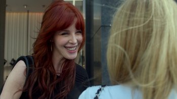 Movie still from “Maps to the Stars” (2014), directed by David Cronenberg – A woman with long red hair smiling at another woman; Close Up shot, Over the shoulder angle