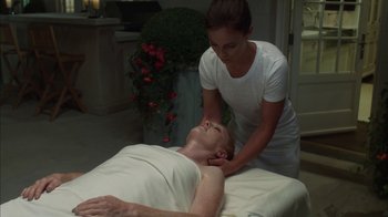 Movie still from “Maps to the Stars” (2014), directed by David Cronenberg – A man is getting a neck massage from a masseuse; Medium shot, High angle