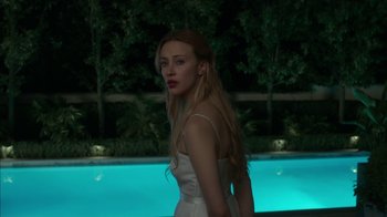 Movie still from “Maps to the Stars” (2014), directed by David Cronenberg – A beautiful young woman standing next to a pool; Medium shot, Over the shoulder angle