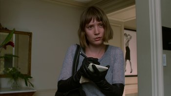 Movie still from “Maps to the Stars” (2014), directed by David Cronenberg – A young woman holding a cell phone in her hands; Close Up shot, Low angle