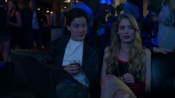 Movie still from “Maps to the Stars” (2014), directed by David Cronenberg – A man and a woman sitting next to each other holding drinks; Medium shot, High angle