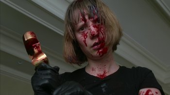 Movie still from “Maps to the Stars” (2014), directed by David Cronenberg – A woman with blood on her face holding a knife; Close Up shot, Low angle