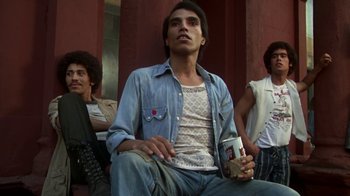 Movie still from “Marathon Man” (1976), directed by John Schlesinger – A group of young men sitting next to each other; Medium shot, Low angle