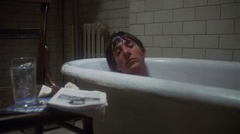 Movie still from “Marathon Man” (1976), directed by John Schlesinger – A man in a bath tub in a bathroom; Medium shot, High angle
