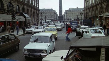 Movie still from “Marathon Man” (1976), directed by John Schlesinger – A busy street filled with lots of traffic and parked cars; Extreme Wide shot, High angle