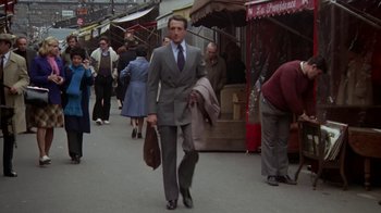 Movie still from “Marathon Man” (1976), directed by John Schlesinger – A man walking down a street with a suit on; Wide shot, Low angle