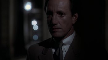 Movie still from “Marathon Man” (1976), directed by John Schlesinger – A person wearing a suit and tie; Close Up shot, Over the shoulder angle