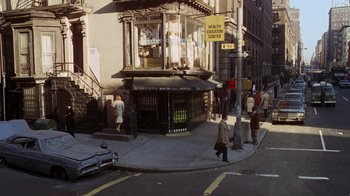 Movie still from “Marathon Man” (1976), directed by John Schlesinger – A group of people walking down a street near a building; Extreme Wide shot, High angle