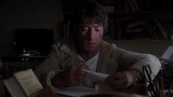 Movie still from “Marathon Man” (1976), directed by John Schlesinger – A man sitting at a table writing on a piece of paper; Close Up shot, Over the shoulder angle