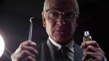 Movie still from “Marathon Man” (1976), directed by John Schlesinger – An older man holding a wrench and a bottle; Close Up shot, Low angle