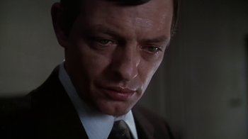 Movie still from “Marathon Man” (1976), directed by John Schlesinger – A man in a suit and tie looking down; Close Up shot, Low angle