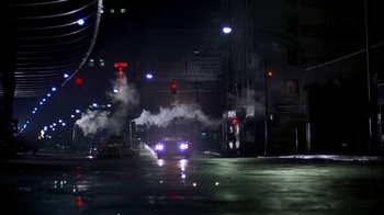 Movie still from “Marathon Man” (1976), directed by John Schlesinger – A car driving down a street at night with smoke coming out of the exhaust; Extreme Wide shot, Low angle