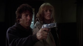 Movie still from “Marathon Man” (1976), directed by John Schlesinger – A man and a woman holding guns in a room; Close Up shot, Low angle